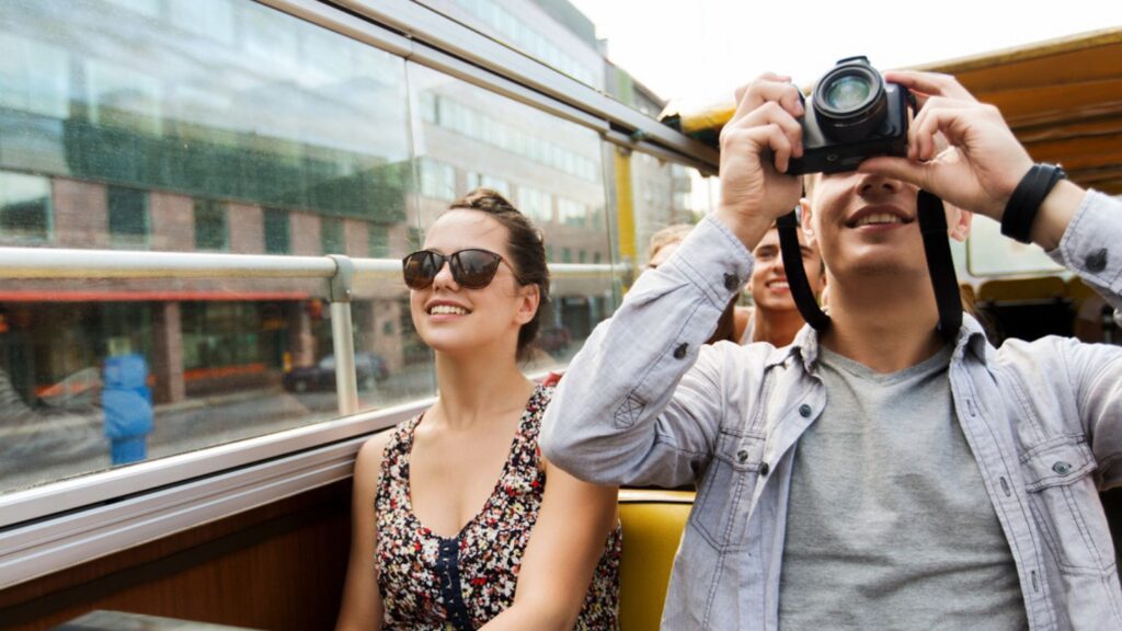 happy tourist traveler couple on tour bus europe