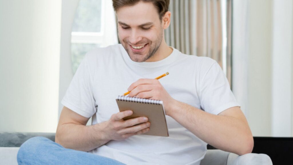 man writing note funny laughing