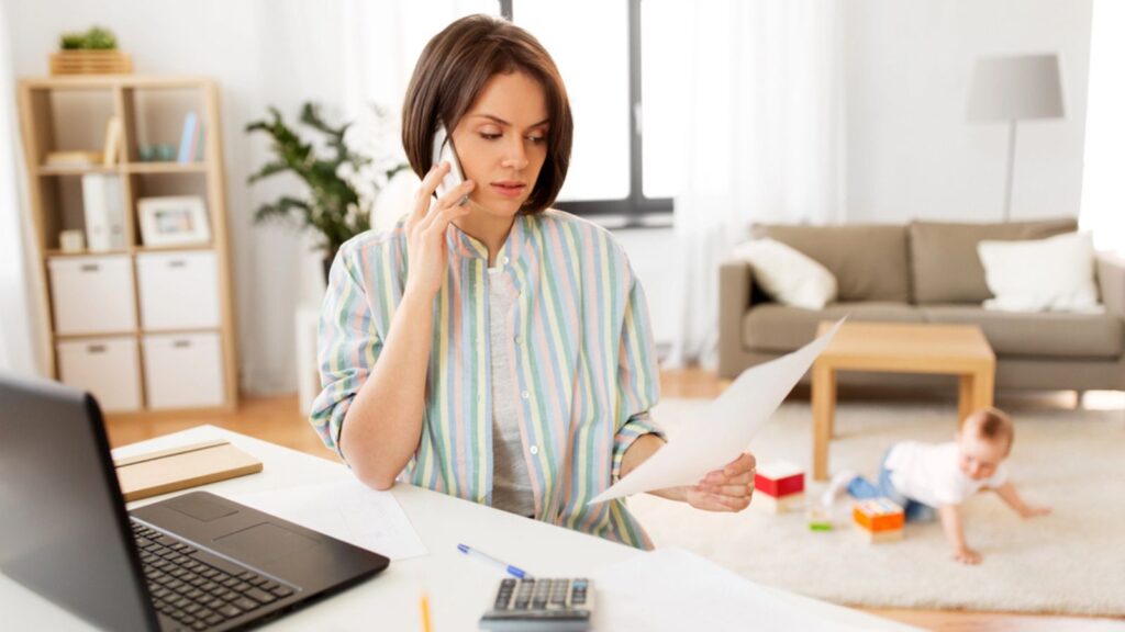 working stay at home remote mom on phone with service provider pay bill