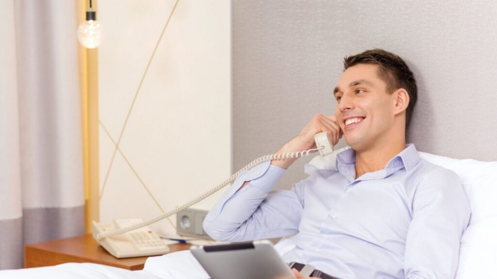 Businessman with tablet pc and phone in hotel room