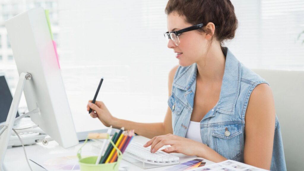 Businesswoman using computer and digitizer