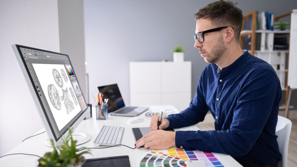 Close-up Of A Graphic Designer's Hand Editing Photo On Computer In Office