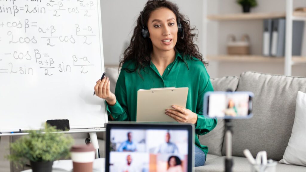 Female teacher in headset explaining math to students online
