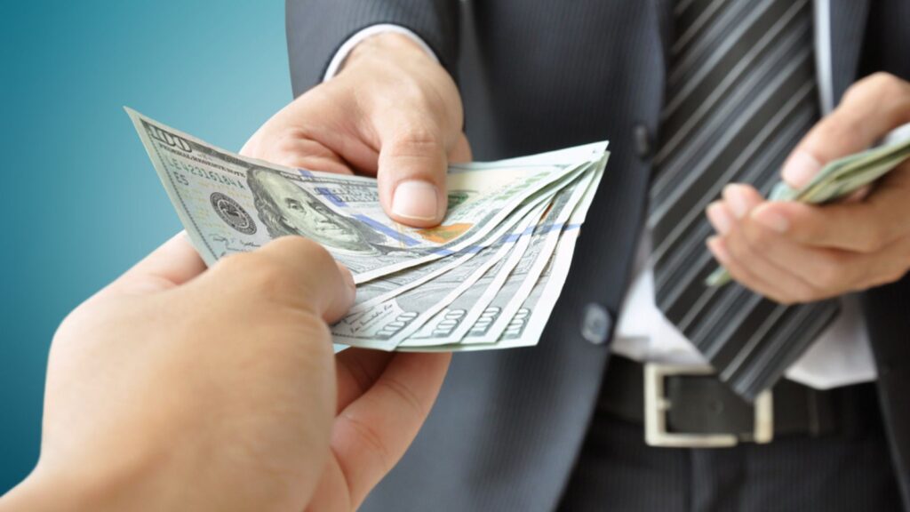 Hand receiving money from businessman
