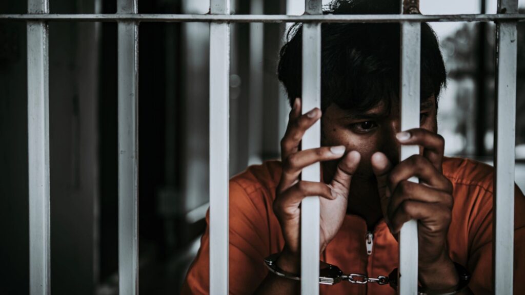 Hands of man desperate to catch the iron prison poverty cause crime.