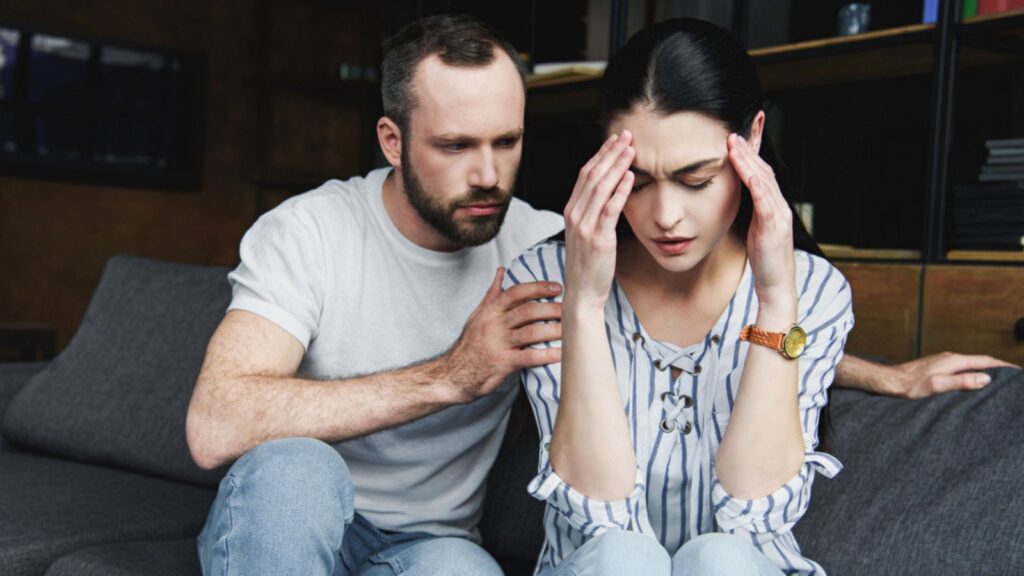 Husband asking forgiveness from wife after couple quarrel at home