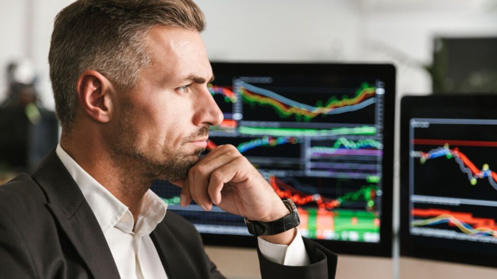 Image of serious businessman working in office on computer