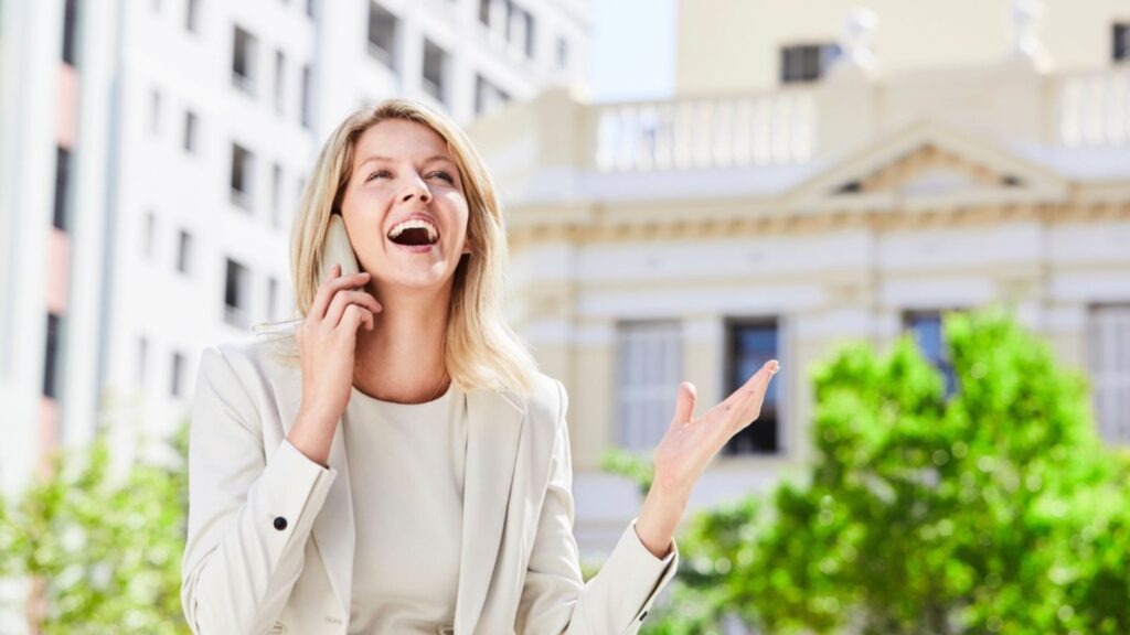Laughing woman talking to someone on her phone