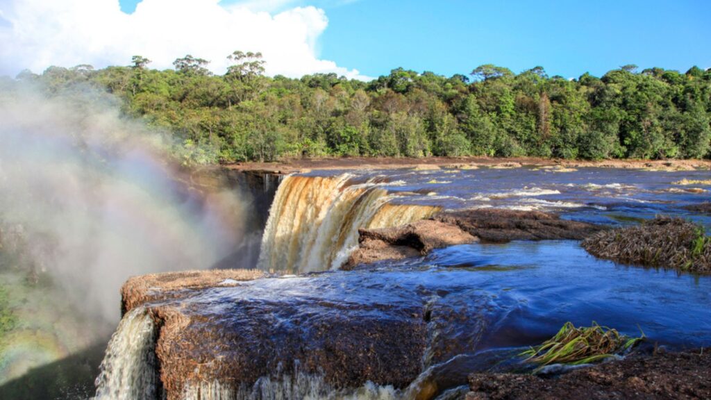The beautiful Kaieteur falls in the Amazon jungle on a clear Sunny day on background of blue sky with clouds, Guyana