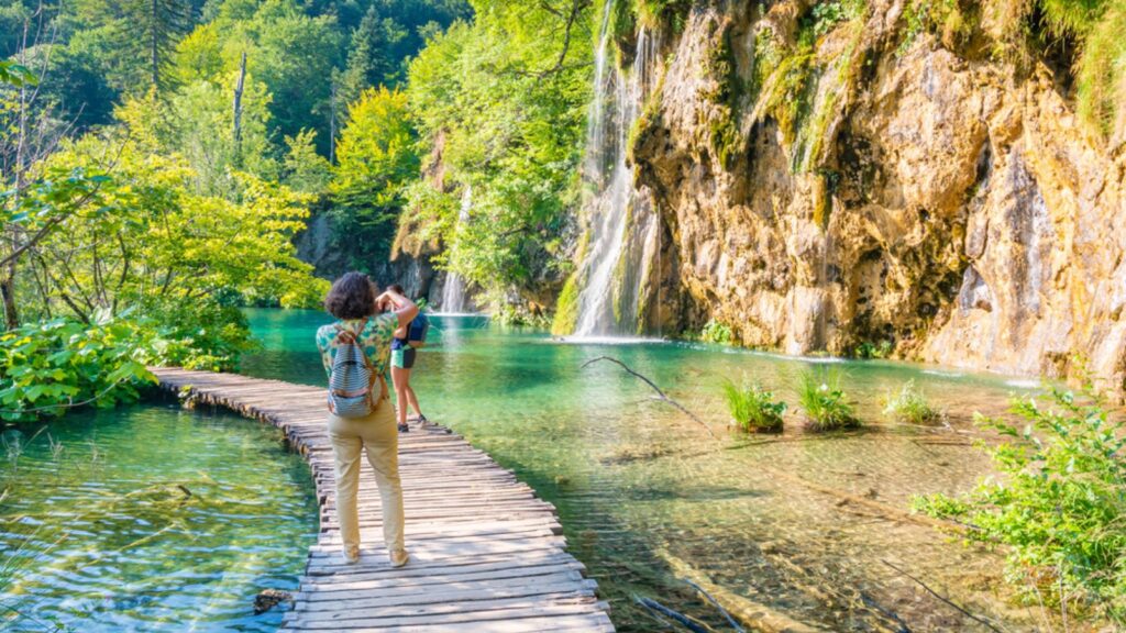 Tourists are visiting the beautiful nature park, Plitvice lakes and waterfalls. Famous travel destination, fresh water in pure nature