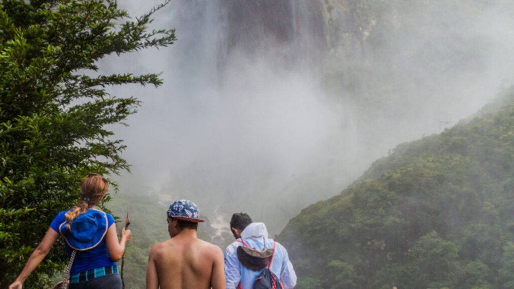 Tourists watch Angel Falls (Salto Angel), the highest waterfall in the world (978 m), Venezuela