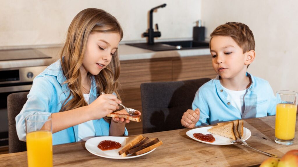 kids eating breakfast jelly toast and orange juice