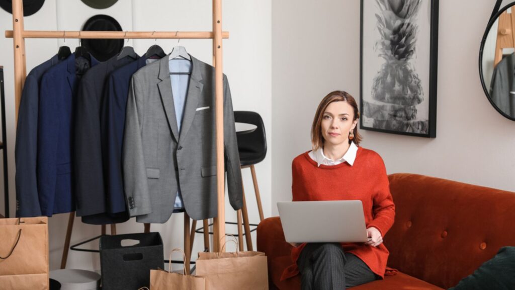 Woman stylist with laptop in her studio