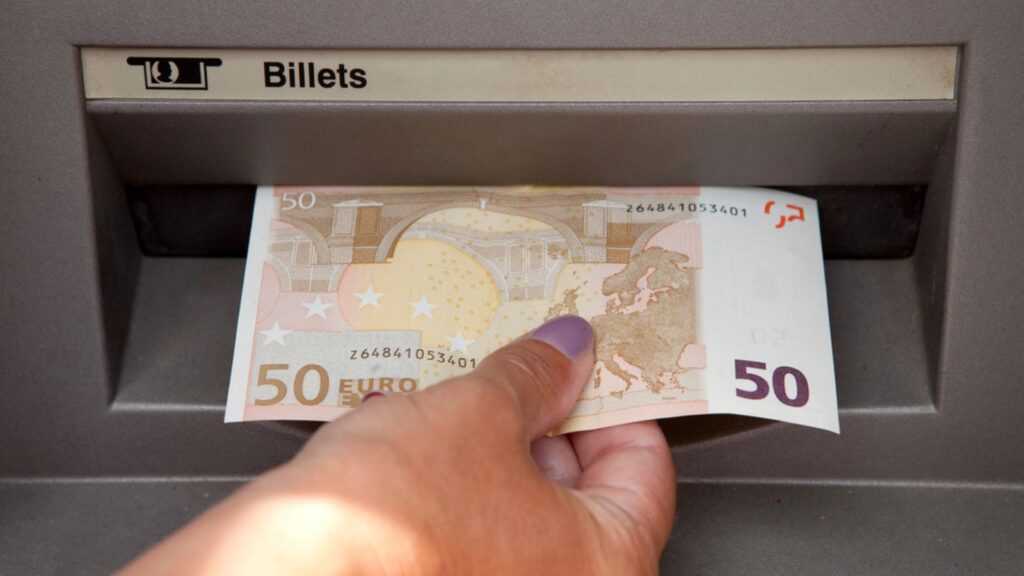 Woman withdraw euro money at cashpoints