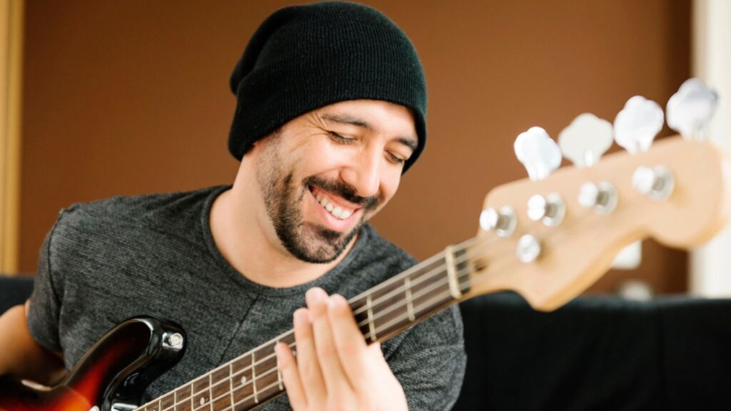 Young man composing music with his guitar