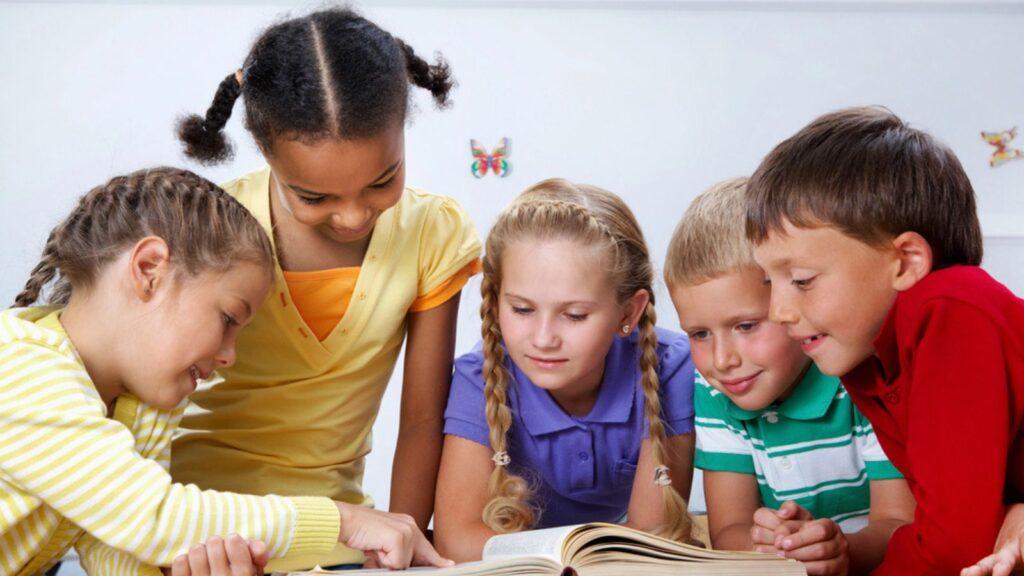 group of diverse young children kids learning reading book