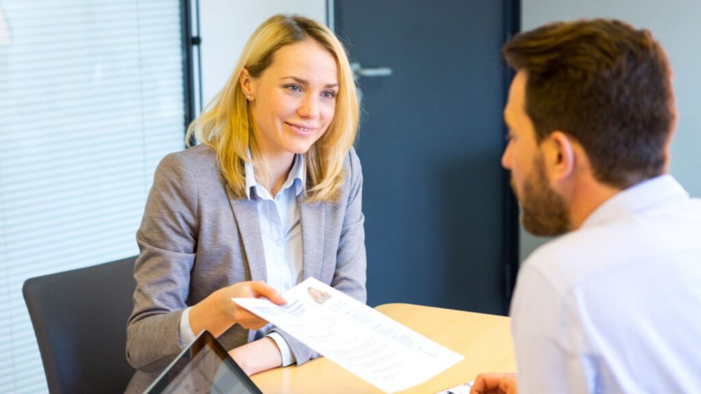 happy professional blonde woman in job interview with resume