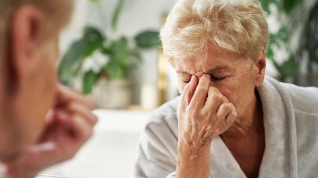 old elderly woman aging stressed upset headache