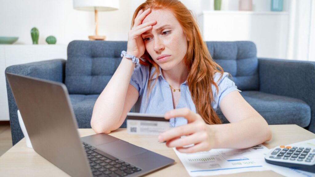 woman sad worried about credit card expenses and budget