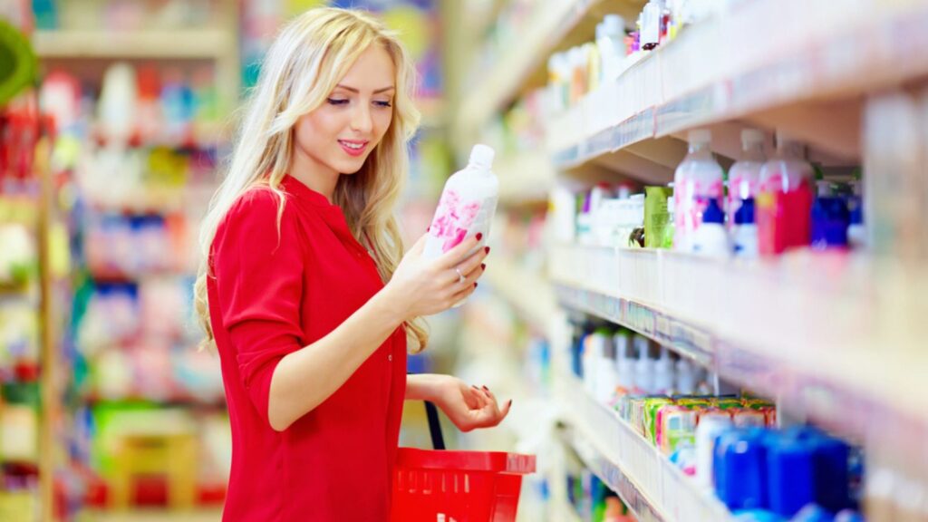 Beautiful woman choosing personal care product in supermarket