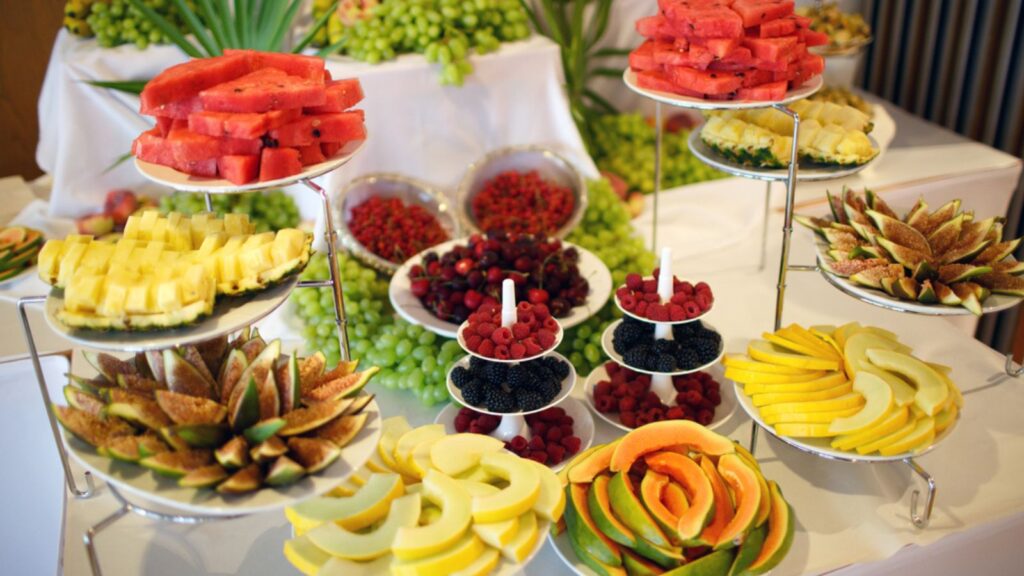 Catering buffet table with fruits, snacks and appetizers
