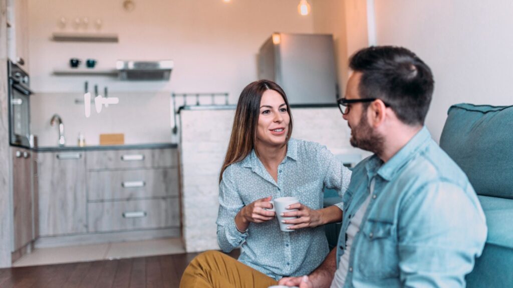 Cute couple talking indoors.