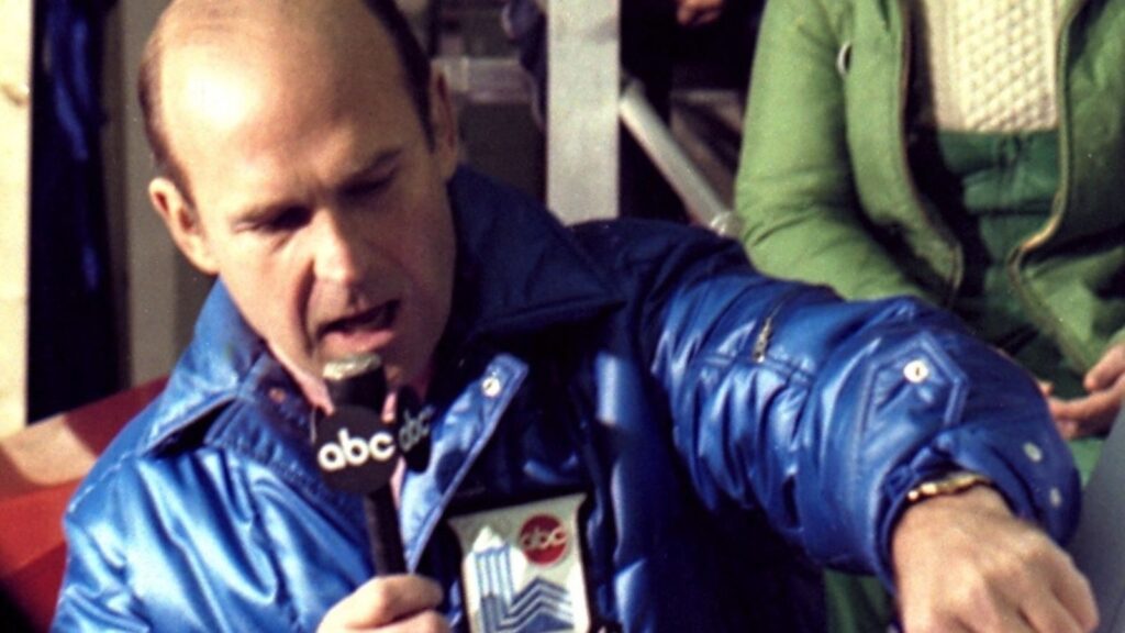 Dick Button describes the figure being skated for the TV audience.