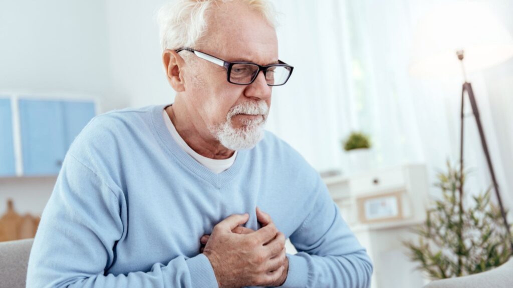 Focused senior man having heart problem