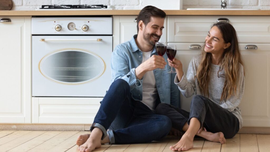 Happy husband and wife relax celebrating anniversary at home
