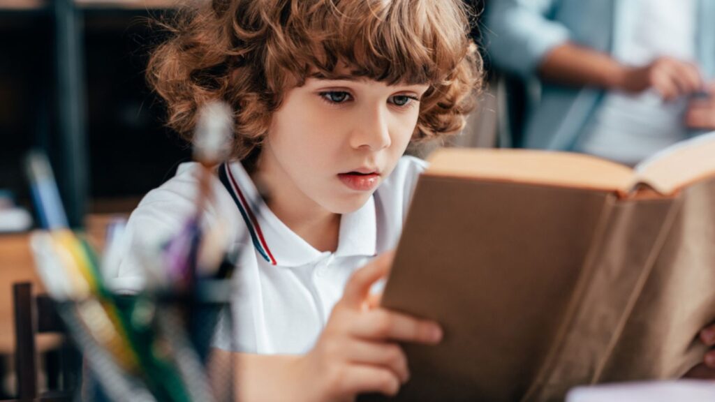 Little boy reading a book