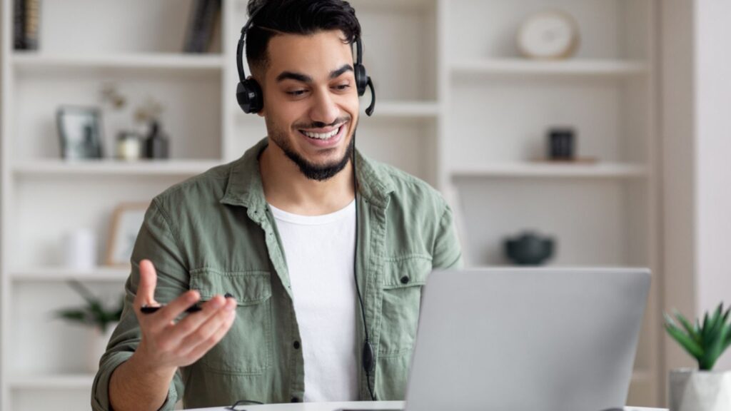 Man talking to a customer on laptop