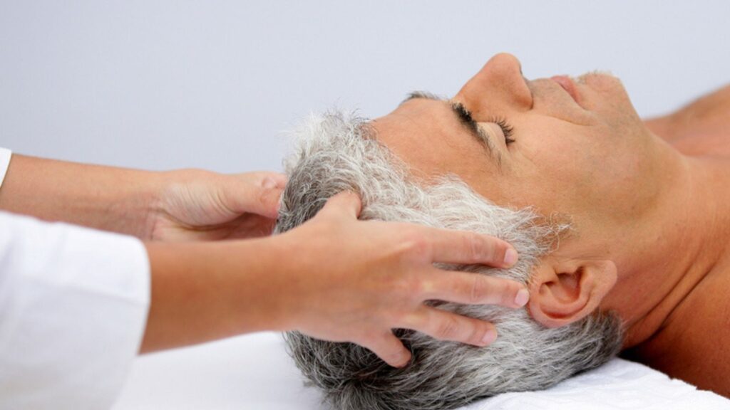 Mature man having a scalp massage