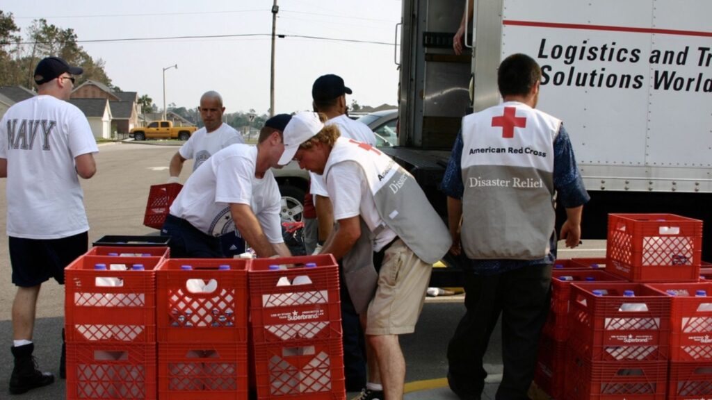 Navy and Red Cross personnel load cartons of bottled water for Hurricane Katrina victims, Biloxi, Mississippi.