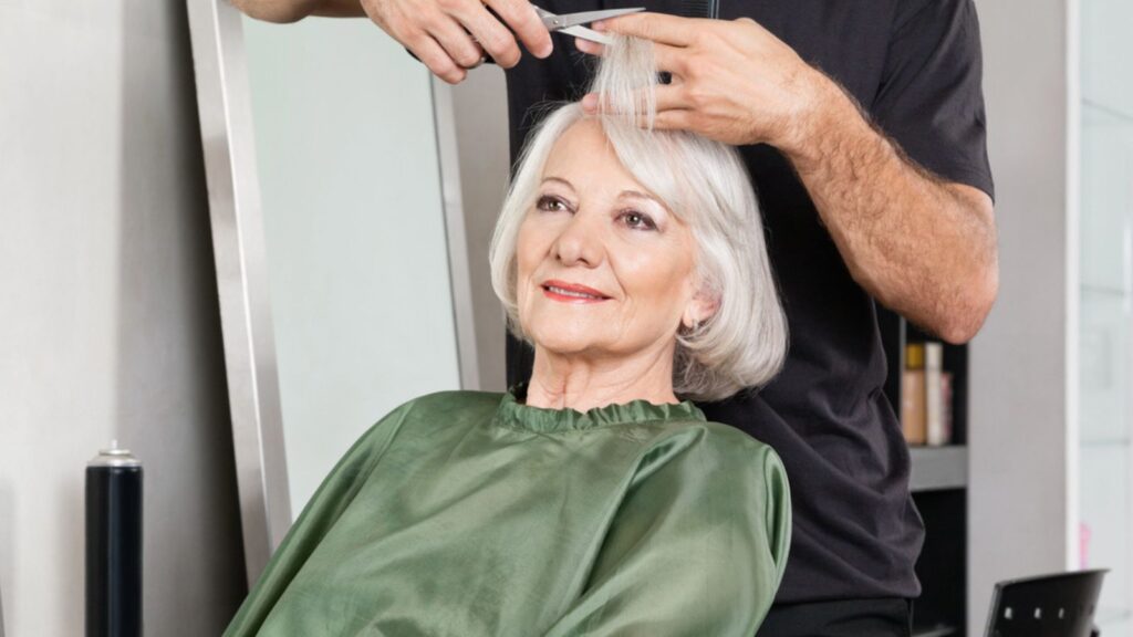 Old Woman Having Hair Cut At Salon