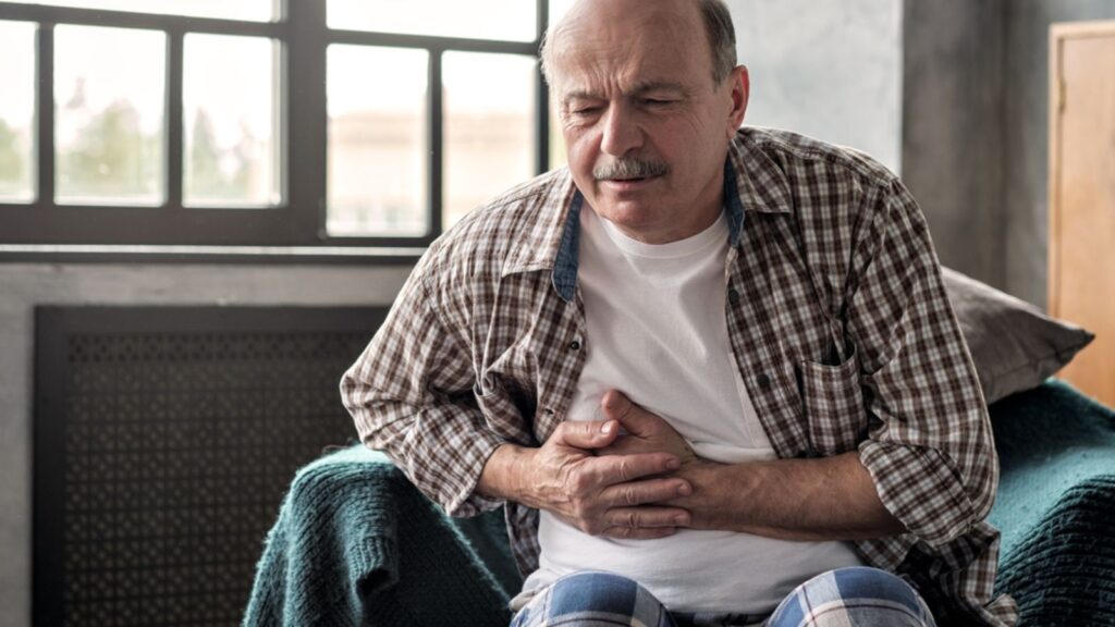 Senior hispanic man is having pancreatitis or gastritis or colitis