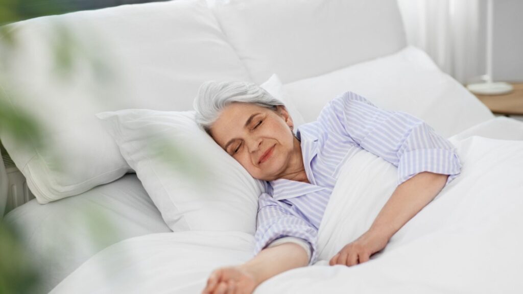 Senior woman sleeping in bed at home bedroom