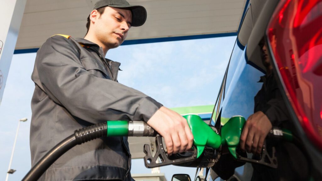 Service man pumping the car in a gasoline station