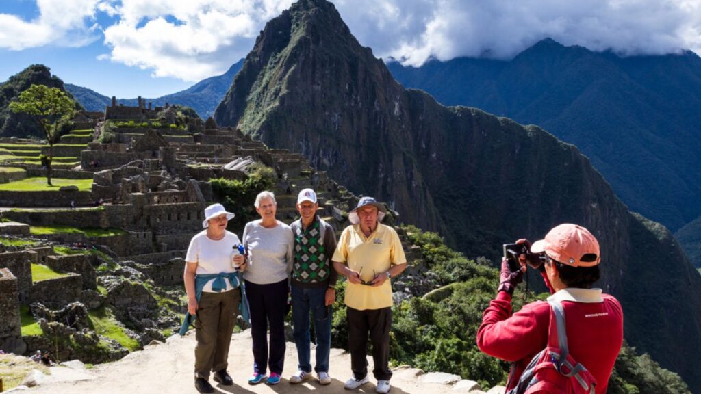 Tourists posing with The lost City of the Incas in the background. May 16 2016, Machu Pichu Peru