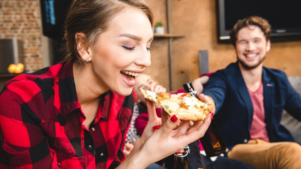 Woman eating pizza at home