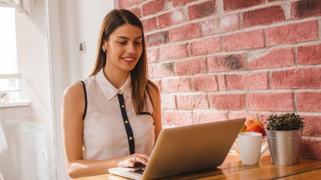 Woman surfing web at home using laptop