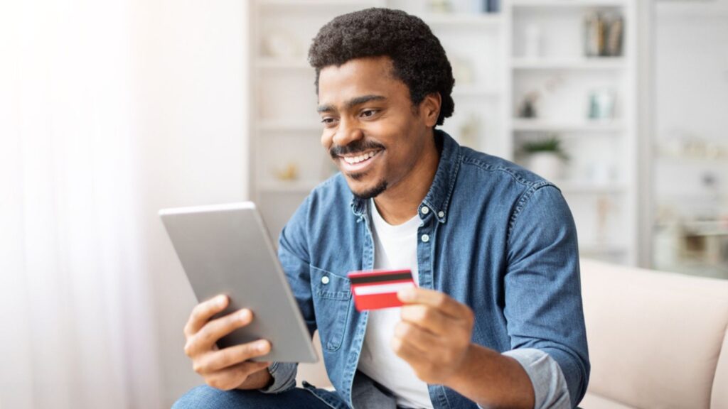 happy man budgeting finances credit card