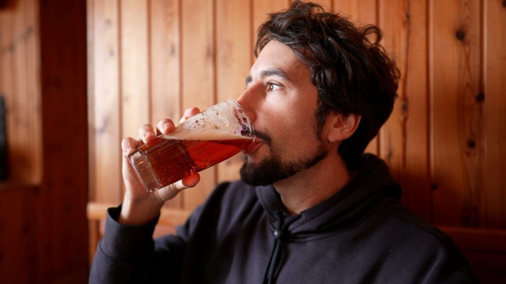 man drinking pint of beer alcohol