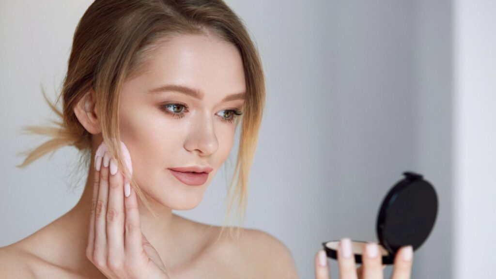 Face Make-Up. Female With Mirror Putting Cosmetic Powder