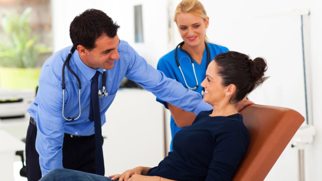 Friendly doctor talking to patient