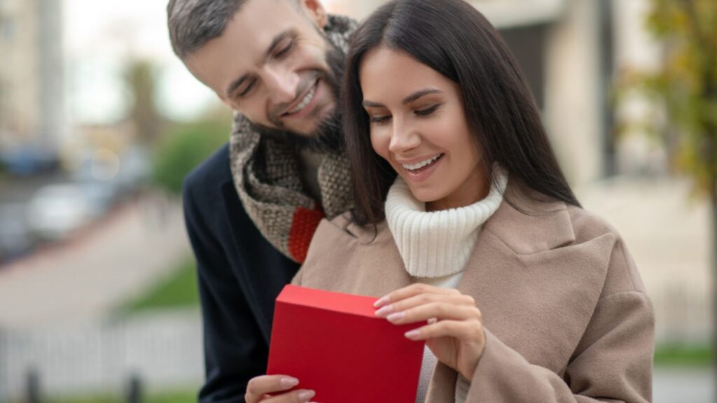 Happy young woman receiving a love letter