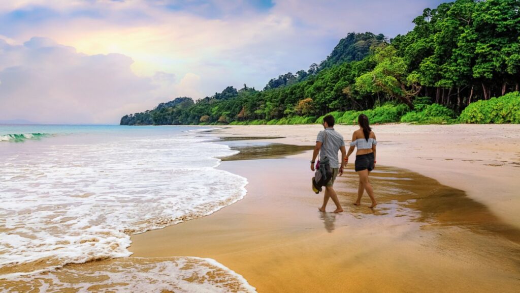 Honeymoon couple take a walk at the scenic Havelock islands beach at Andaman India