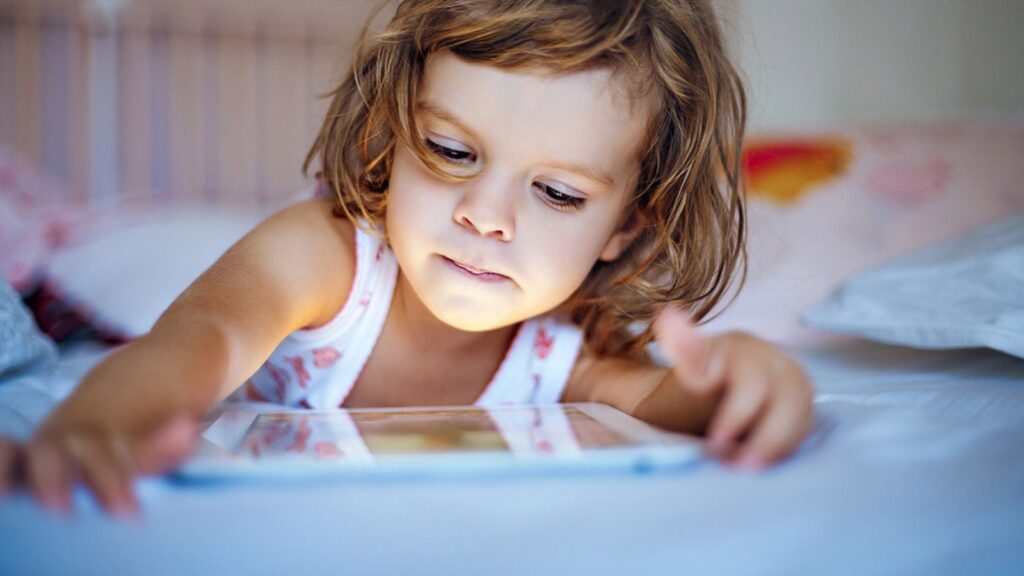 Little girl playing tablet