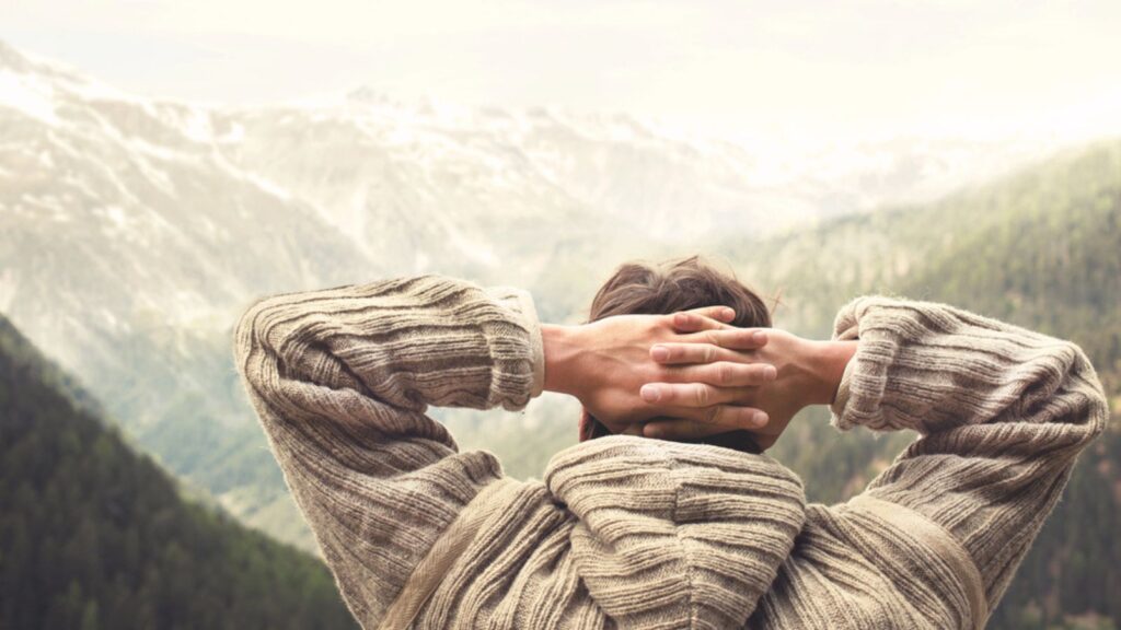 Relaxed man observing majestic mountain