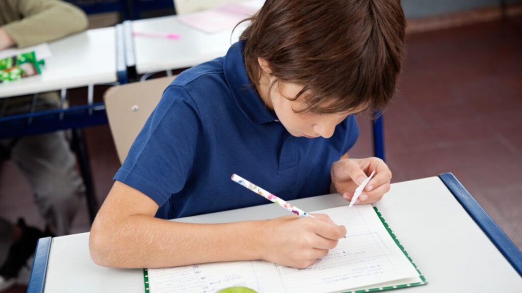 Schoolboy Copying From Cheat Sheet During Examination