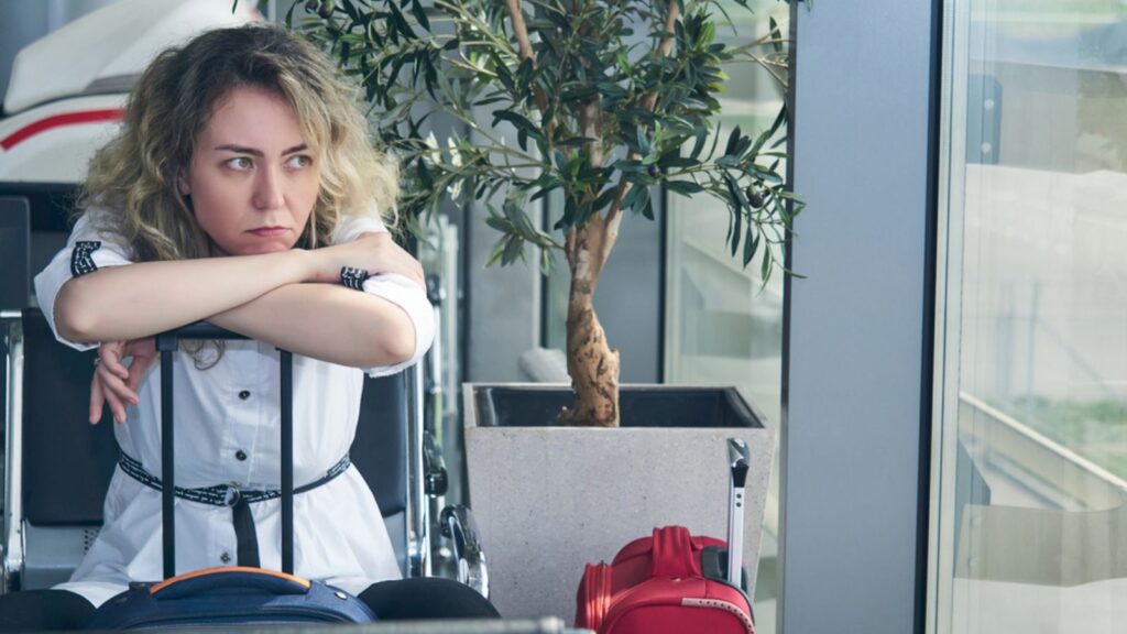 Young woman tourist traveler with baggage luggage airport annoyed
